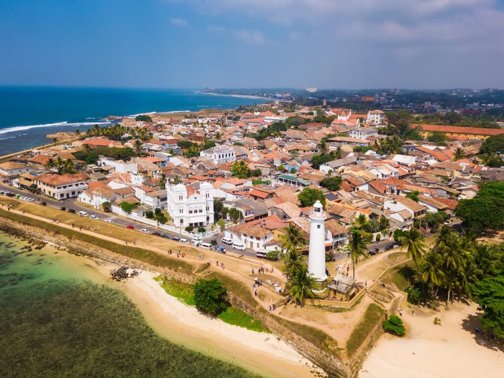 A view from a distance of the detailed Dutch colonial architecture of Galle Fort, Sri Lanka, with its colourful balconies and doorways.