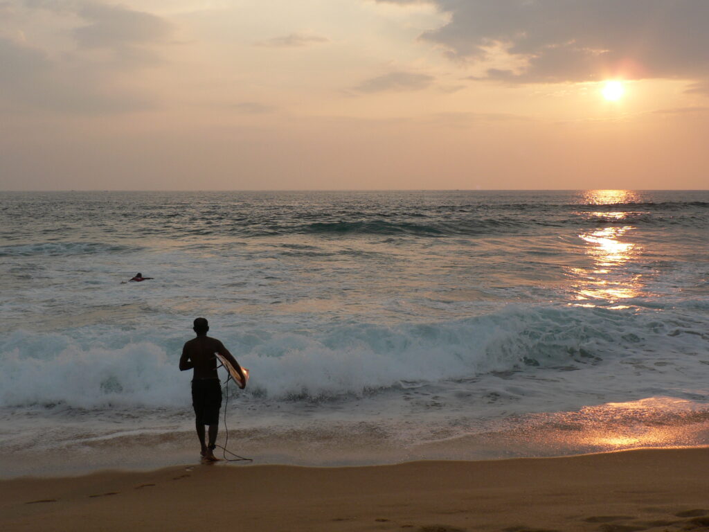 People come to spend their holiday in Sri Lanka relaxing on the golden sand of Hikkaduwa Beach, Sri Lanka.